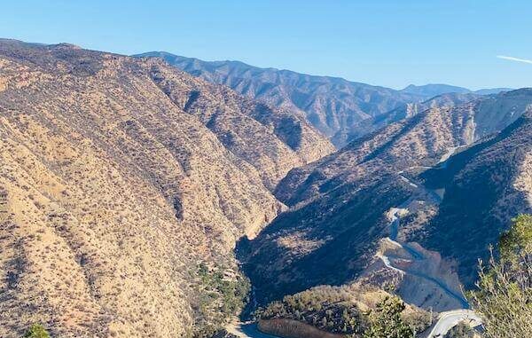 Stunning view of Paradise Valley near Agadir, featuring turquoise natural pools, lush palm trees, and rocky cliffs.