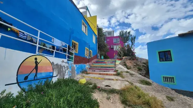 Tourist walking through colorful Aghroud alleyways