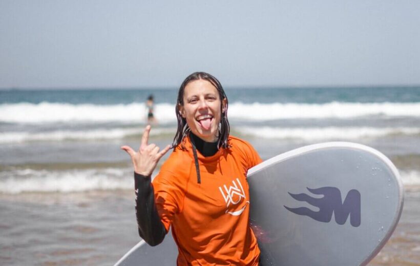 Group of surf students holding boards on Agadir beach