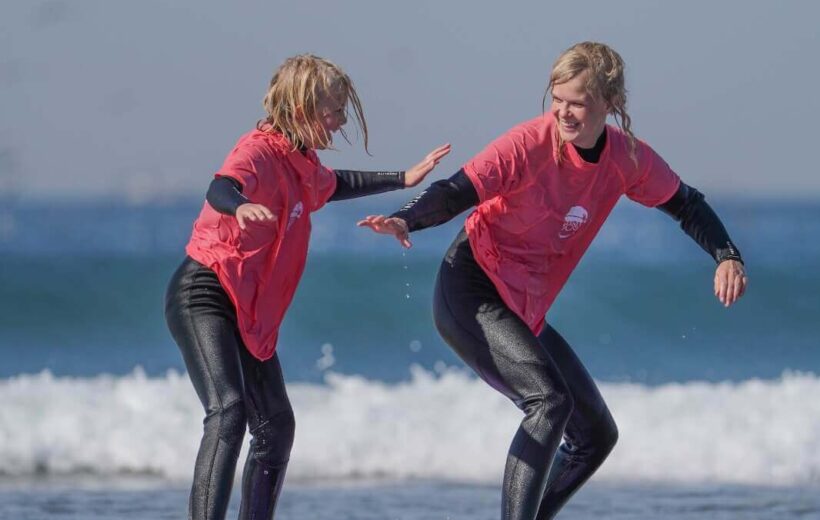 Surf coach explaining pop-up technique on Agadir beach