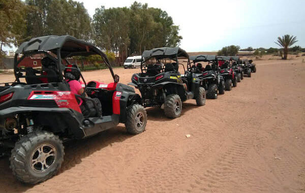 Tourists engaging with locals during a buggy tour in Agadir.