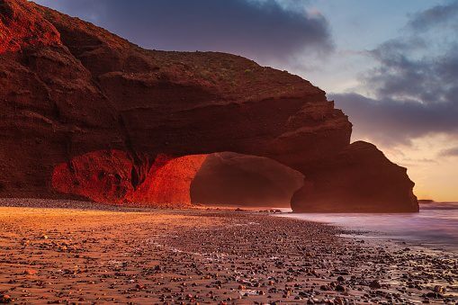 Legzira Beach red sandstone arches Morocco