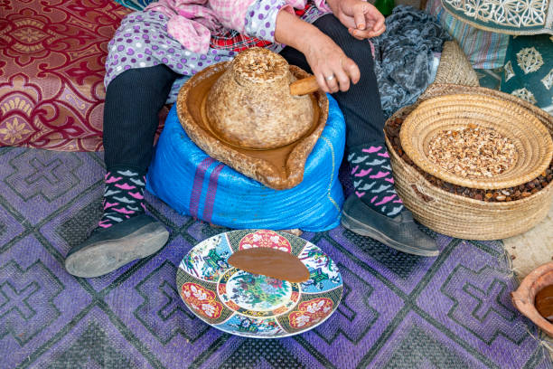 Woman demonstrating argan oil production near Agadir
