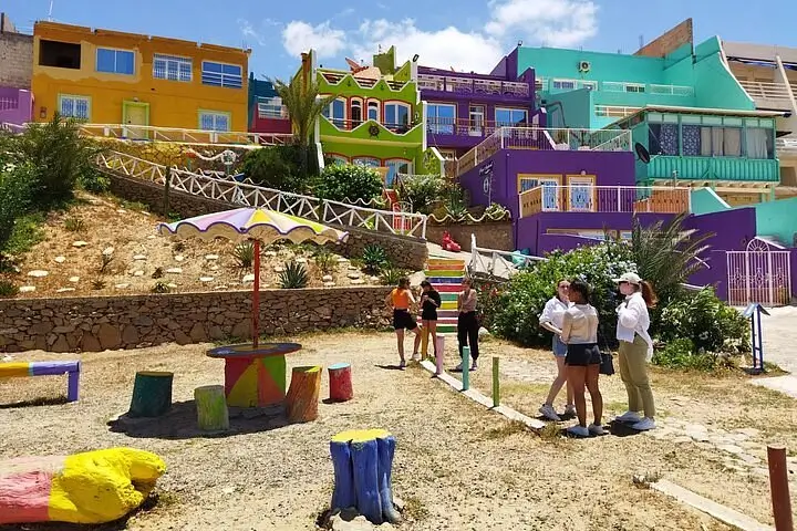 Sandboarding at Timlalin dunes during a day trip from Marrakech with a cultural stop at Aghroud Village near Agadir.
