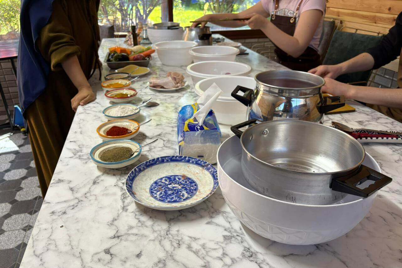 Traditional Moroccan tagine being cooked during a cooking class in Tamraght.