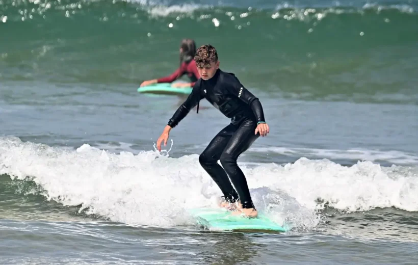 Surfers enjoying sunset waves in Agadir