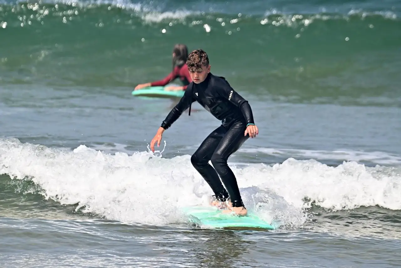 Surfers enjoying sunset waves in Agadir