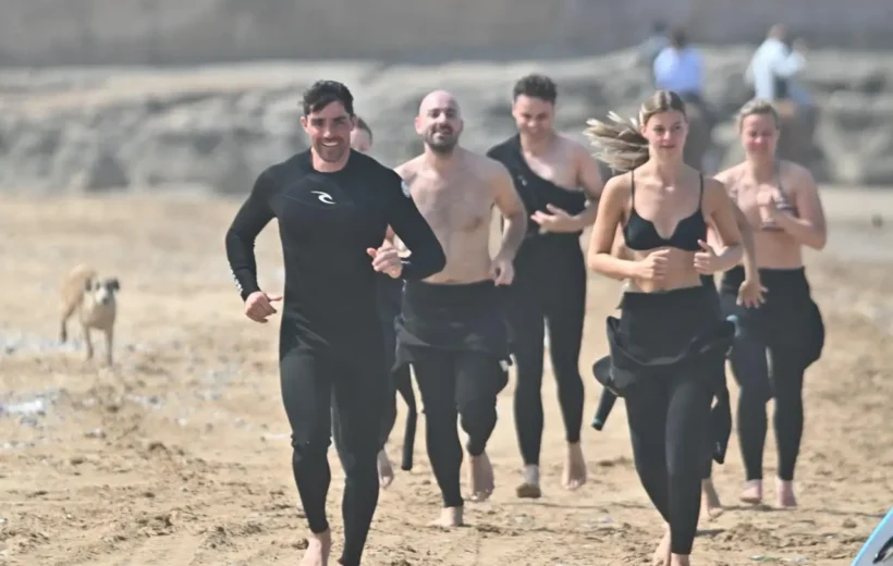 Group of beginners learning to surf on Taghazout beach