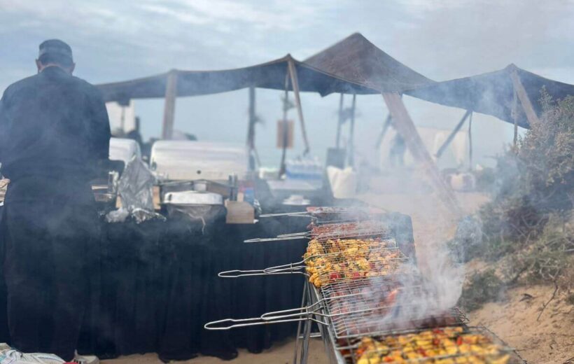 Traditional barbecue dinner prepared in the desert near Taghazout at sunset