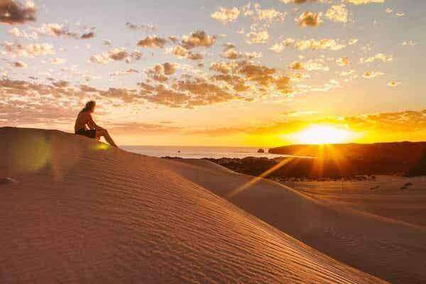 Sandboarding in Agadir on golden desert dunes near the Atlantic coast
