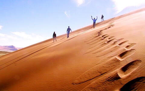 Visitors exploring the Timlalin sand dunes on a desert tour from Agadir