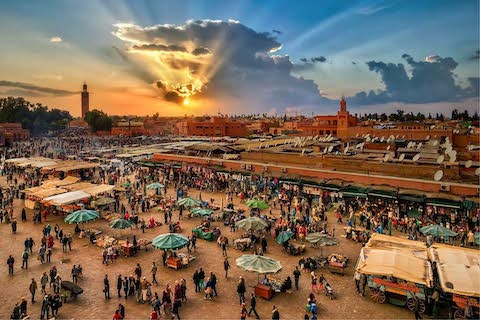 Private Marrakech Day Trip from Agadir at Jemaa el-Fnaa Square with traditional Moroccan street performers